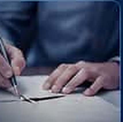 Signing legal paperwork at a desk